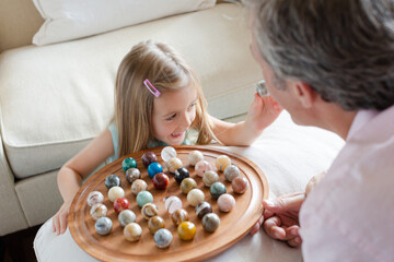 Father and daughter playing Chinese checkers