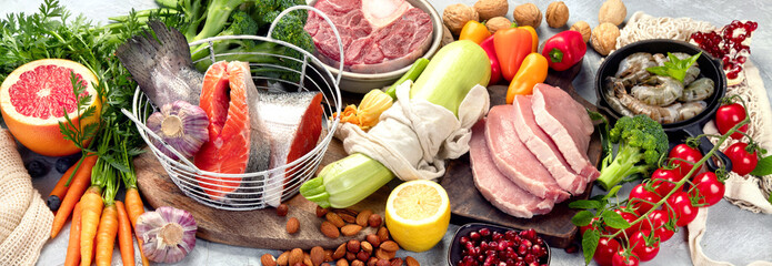 Paleo diet food on light gray background.