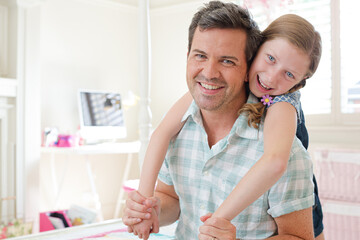 Fototapeta premium Father and daughter hugging in bedroom