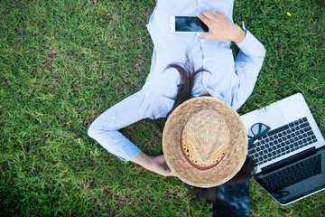 Woman lay down sleep on green grass meadow garden summer sunshine day happy time outside. Hipster...