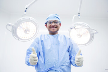 Naklejka premium Asian surgeon ,operating room at the hospital The surgeon team is performing the surgery. A middle-aged doctor looks at a camera in a modern operating room.