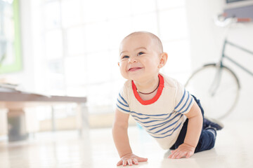 Baby boy crawling on living room floor