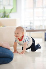 Baby boy crawling on living room floor