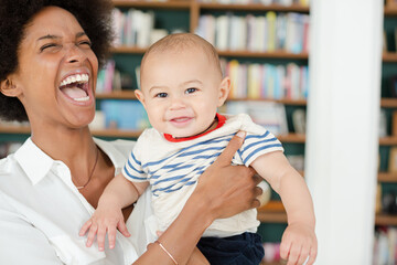 Mother holding baby boy in living room