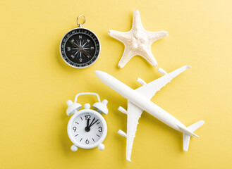 World Tourism Day, Top view flat lay of minimal toy model plane, airplane, starfish, alarm clock...