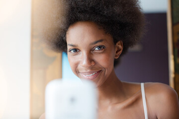 Smiling woman using cell phone