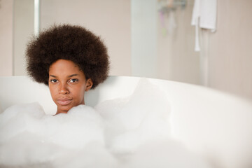 Woman playing with bubbles in bath