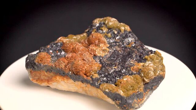 Some shots of a mineral with oxidized baryte on a bed of blende, with black, orange and yellow colors. About 15 centimeters in size. Mineral found in the south of France.