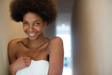 Smiling woman wrapped in towel