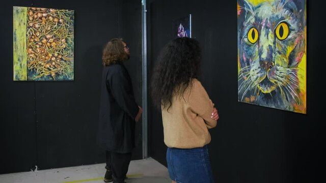 exhibition of fine art objects in trendy art gallery and visitors