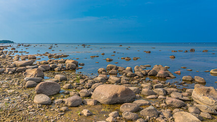 Rocky seaside. A lot of stones on the seashore.