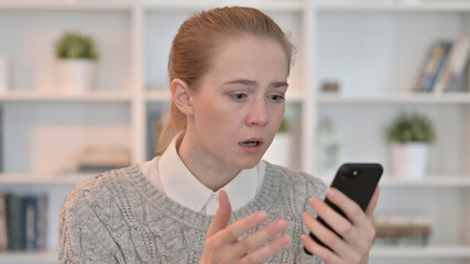 Woman Reacting to Loss on Smartphone