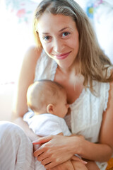 Fototapeta na wymiar Mother breast-feeding baby boy