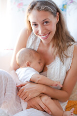 Mother breast-feeding baby boy