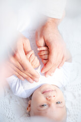 Fototapeta na wymiar Father holding baby boy's hands