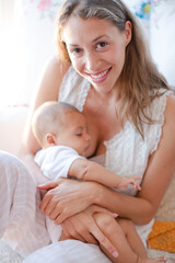 Mother breast-feeding baby boy