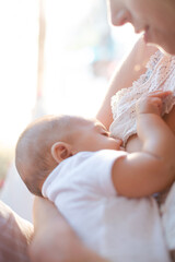 Mother breast-feeding baby boy