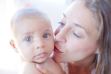Mother kissing baby boy's cheek