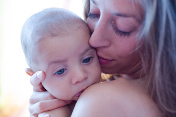 Bare chested mother holding baby boy