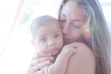 Bare chested mother holding baby boy