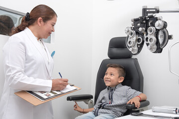 .Children are treated for visual health problems..Doctor writes a prescription to a boy with vision problems.