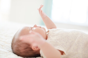 Baby girl laying on bed