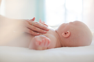 Mother touching baby girl