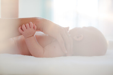 Mother touching baby girl