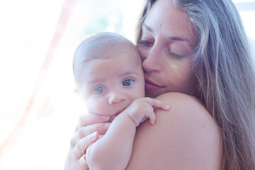 Bare chested mother holding baby boy