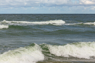 Landscape sea evening at the Baltic Sea, the sun reflects on the waves,some clouds in the sky, morning