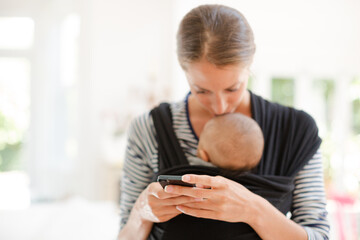 Mother with baby boy using cell phone