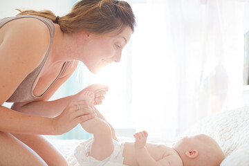 Mother playing with baby girl