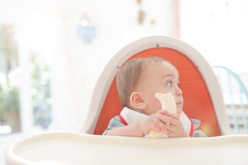Baby girl eating in high chair