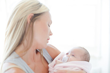 Mother holding baby girl