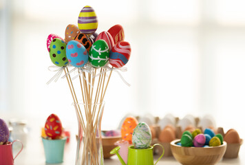 Fototapeta premium Close up of colorful easter eggs Skewers There is a side area for texts. In the concept of Easter eggs with a blurred background technique.