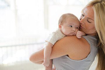 Mother holding baby girl in nursery