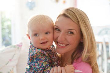 Mother holding baby girl