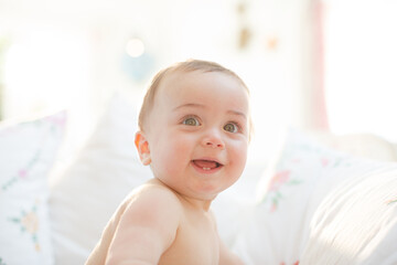 Baby boy smiling on bed