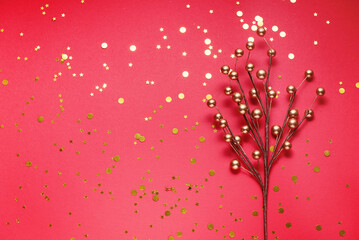 Golden branch christmas decoration with sparkles on red festive background with copy space. concept background new year school concept