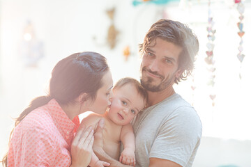 Obraz premium Parents smiling with baby boy