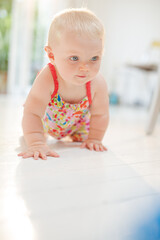 Baby girl crawling on floor