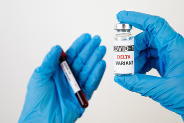 Vaccine bottles covid - 19 delta variant, vials medicine and syringe injection isolated on white. Coronavirus DELTA 2019-ncov. Vaccine bottles on the woman hand