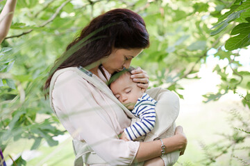 Mother holding baby boy outdoors