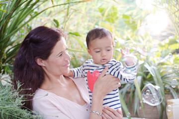 Obraz premium Mother holding daughter outdoors