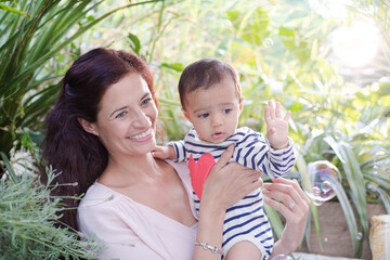 Mother holding daughter outdoors