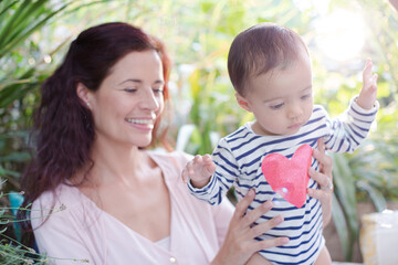 Mother holding daughter outdoors