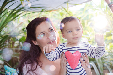 Mother holding daughter outdoors