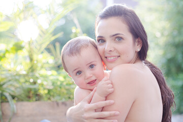 Mother holding baby boy outdoors