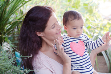 Mother holding daughter outdoors