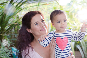 Mother holding daughter outdoors
